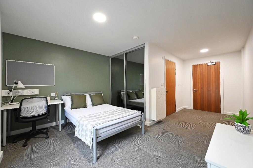 A bright and modern double bedroom featuring a ...