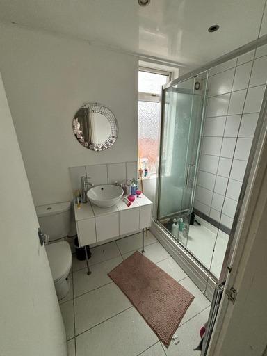 A clean and well-maintained bathroom with a sho...