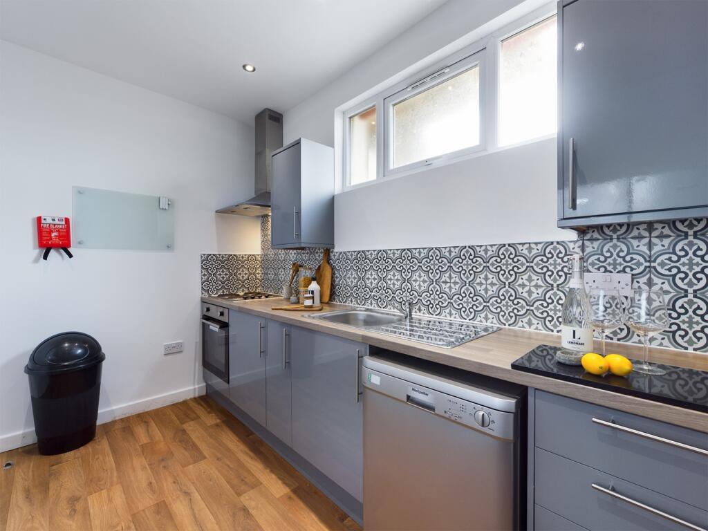 A modern and stylish kitchen featuring ample co...