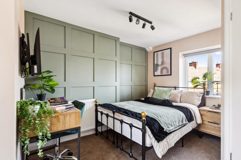 A beautifully styled double bedroom featuring a...