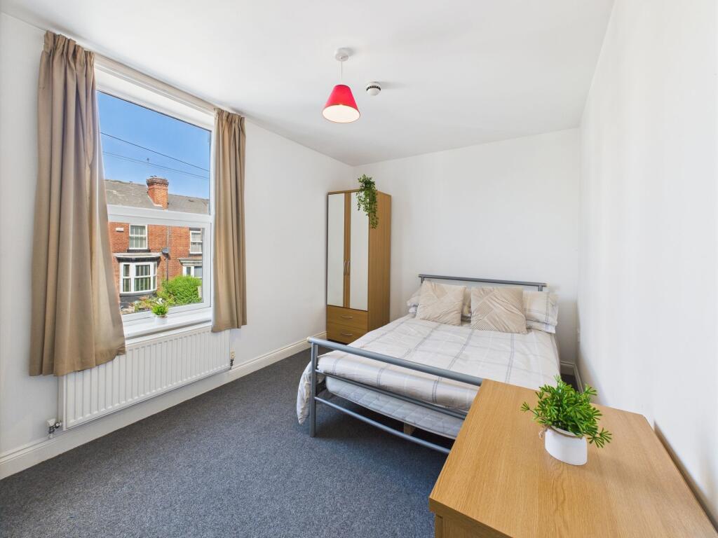 Bright and inviting bedroom featuring a comfort...