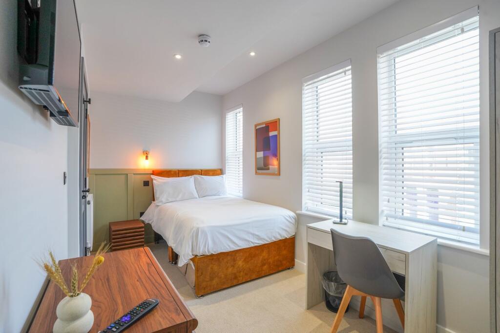 Bright and inviting master bedroom featuring a ...