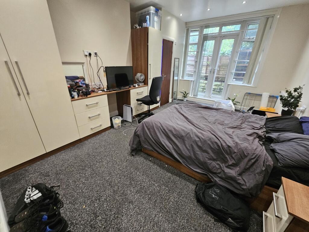 Spacious master bedroom featuring ample natural...