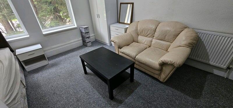 Bright, simply furnished living area with large...