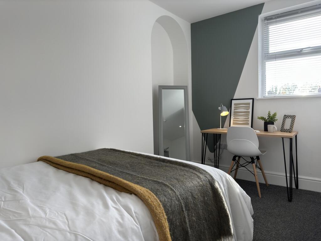 A bright and inviting double bedroom with moder...