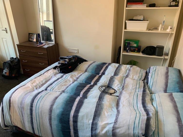 A welcoming double bedroom featuring a cozy bed...