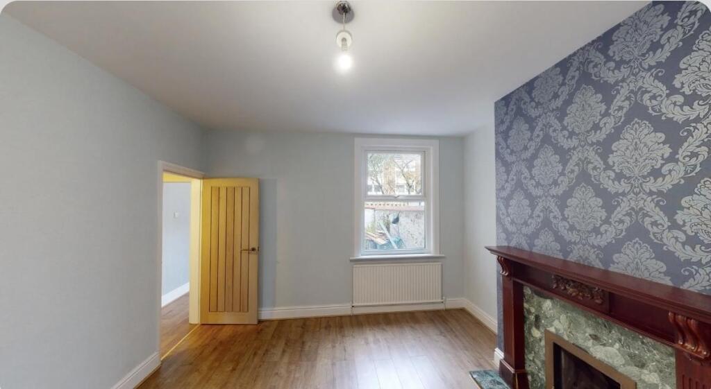 A charming living room featuring elegant firepl...