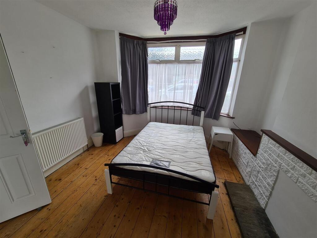 A cozy double bedroom featuring large windows t...