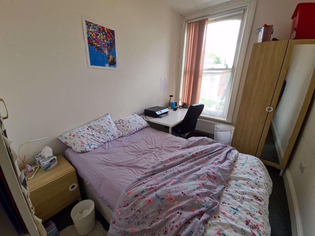 A cozy single bedroom featuring a comfortable b...