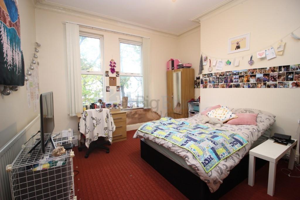 A cozy double bedroom featuring a comfortable d...