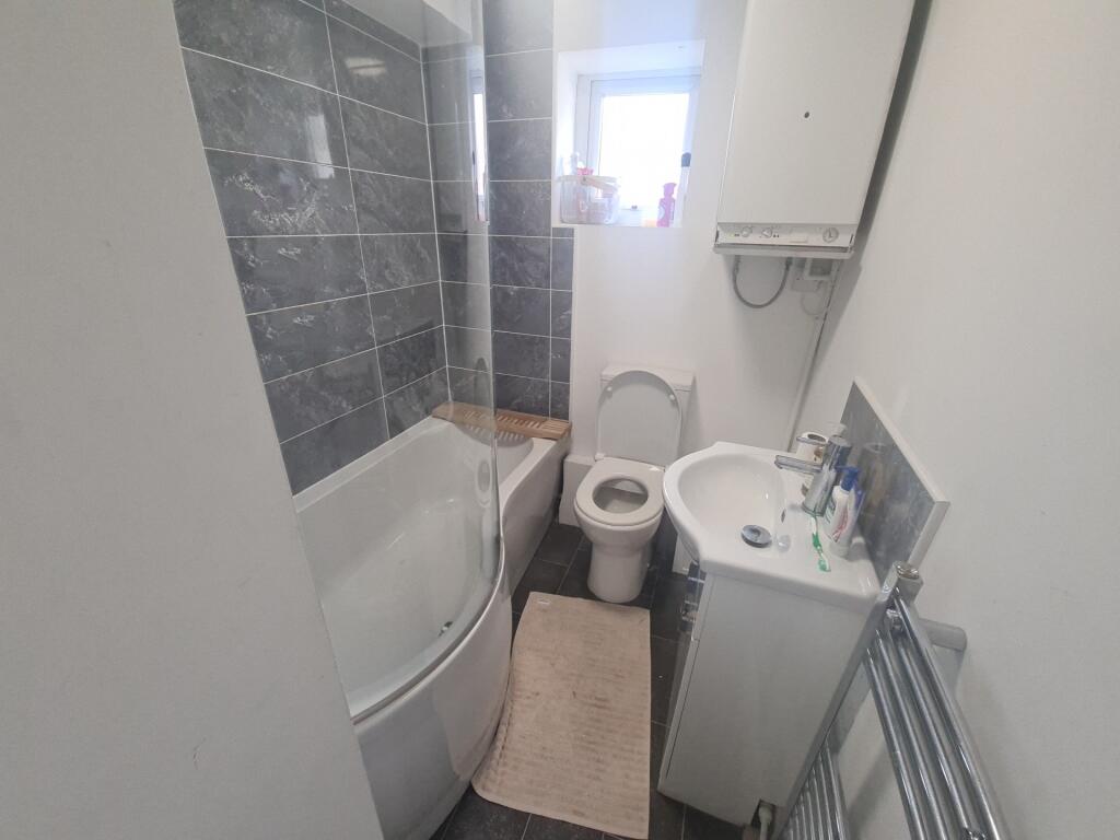 A clean and functional bathroom with a shower c...