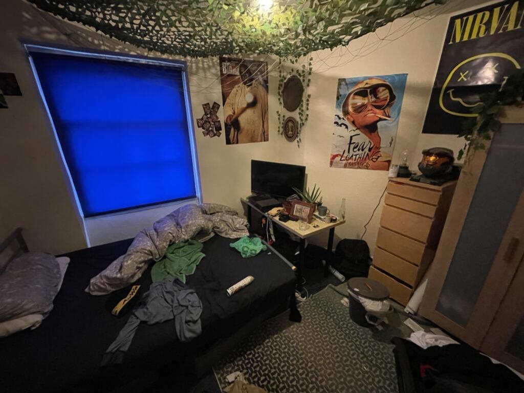 Cozy double bedroom featuring a vibrant blue wi...