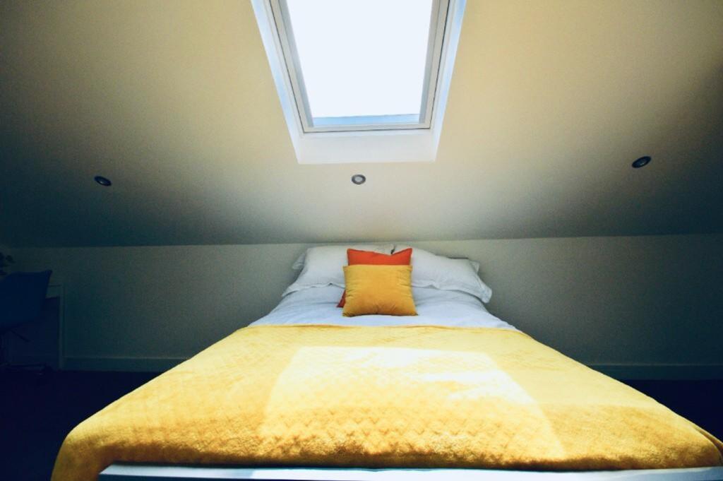 A bright and inviting double bedroom with a coz...
