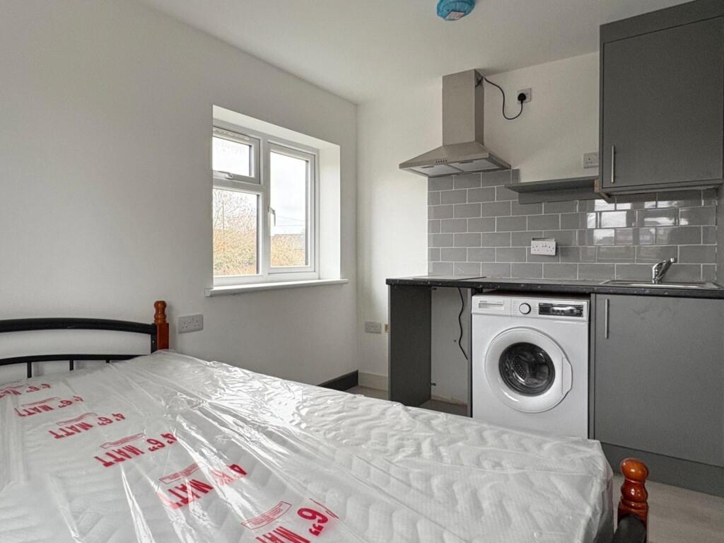 Bright, simply furnished bedroom with a double ...