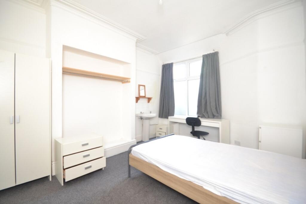This inviting double bedroom features ample spa...