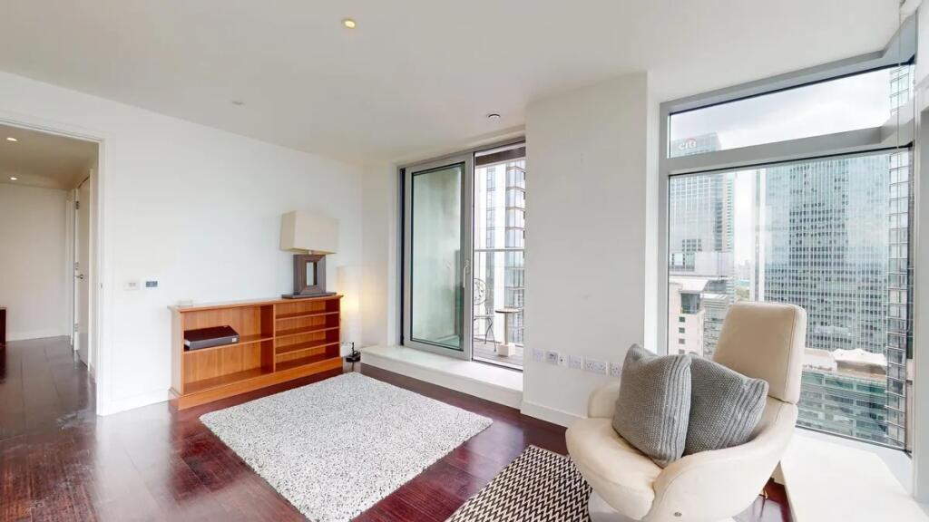 Bright and modern living room featuring floor-t...