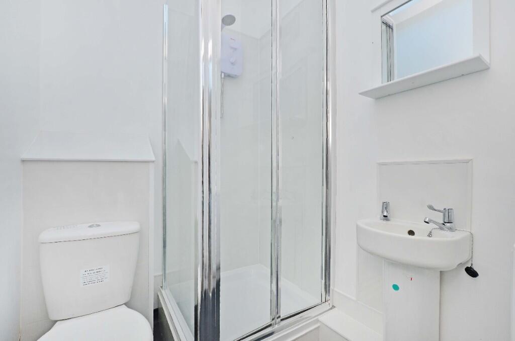 Bright and pristine bathroom featuring a modern...