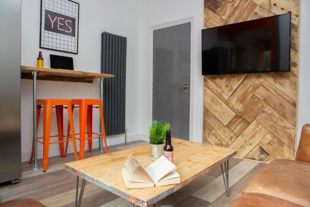 A stylish living room featuring a modern wall-m...