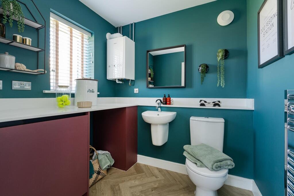 A guest cloakroom also hosts space for laundry appliances