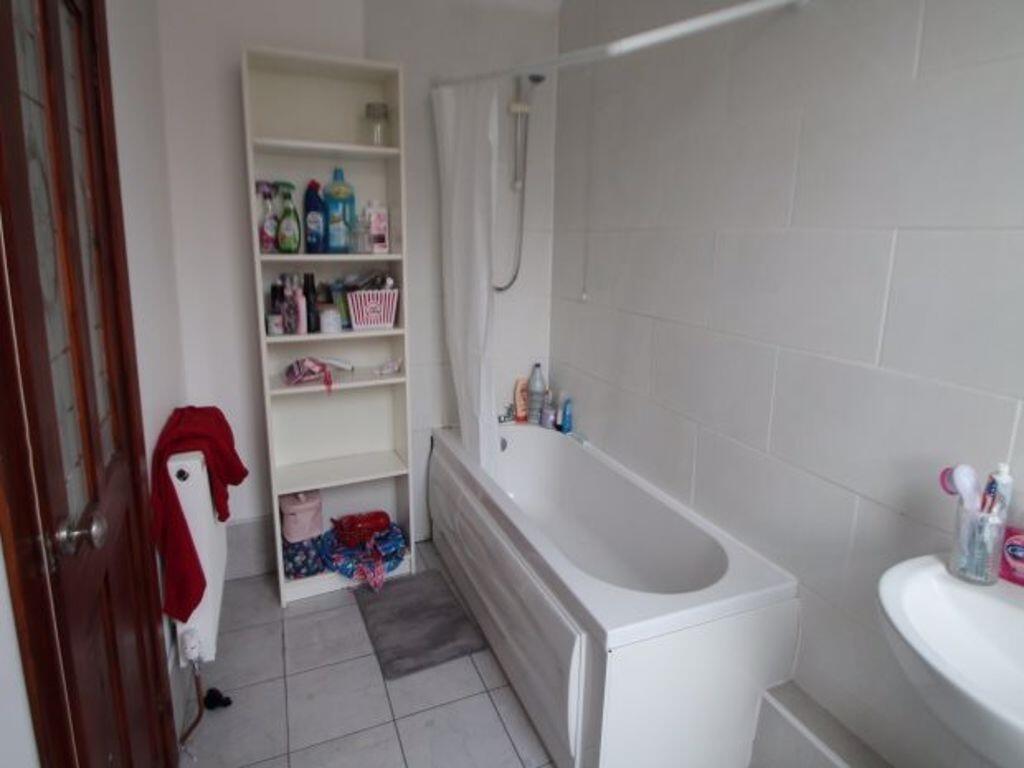 A clean, modern bathroom with a spacious bathtu...