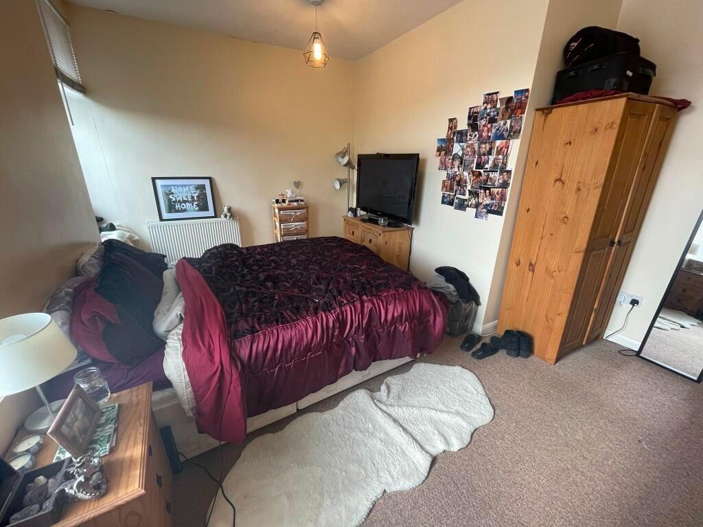Cozy double bedroom featuring a comfortable bed...