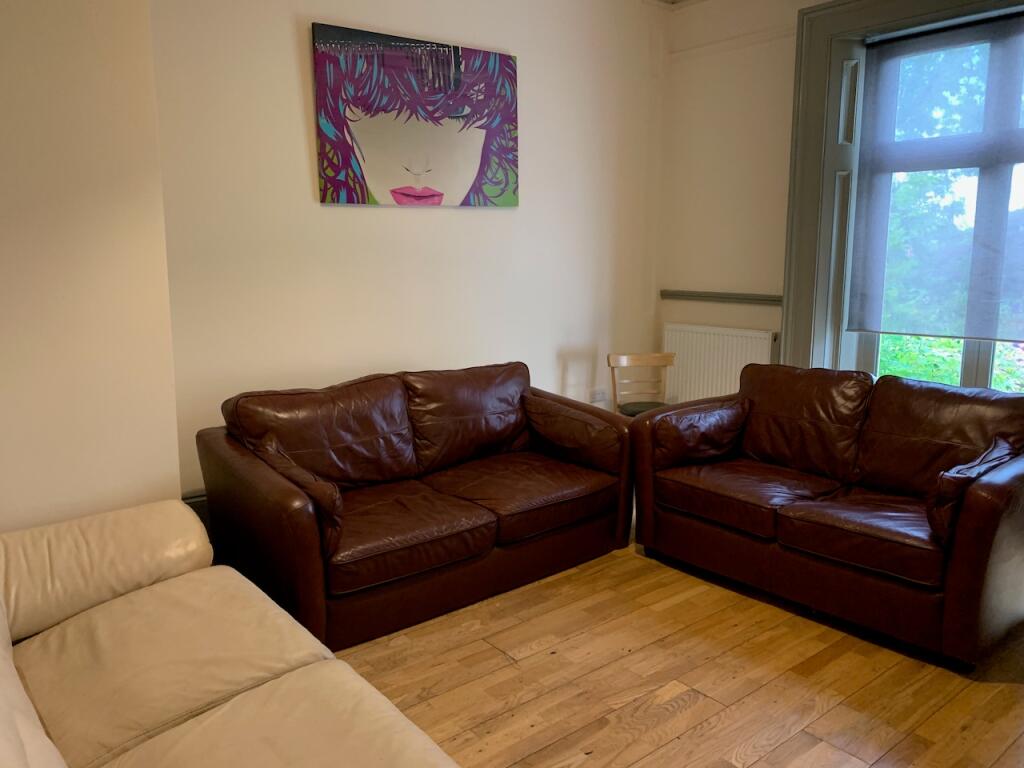 A cozy living room featuring two brown leather ...