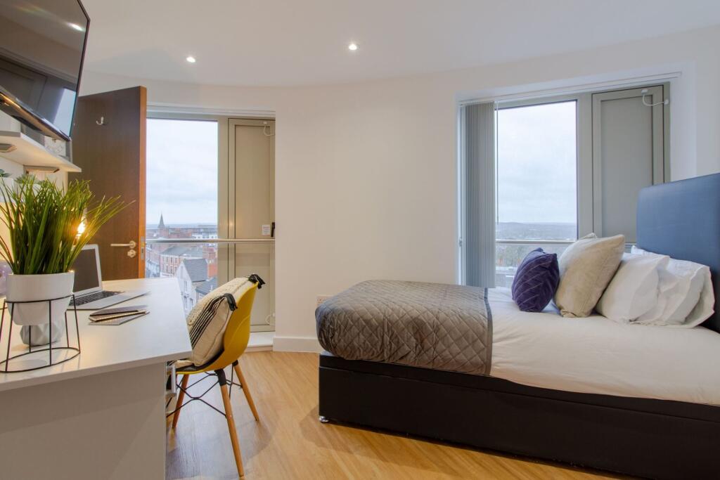 Bright and modern single bedroom featuring larg...