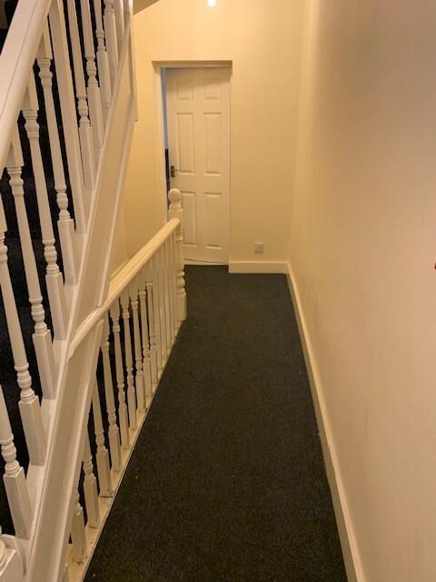 A tidy and well-maintained hallway featuring a ...