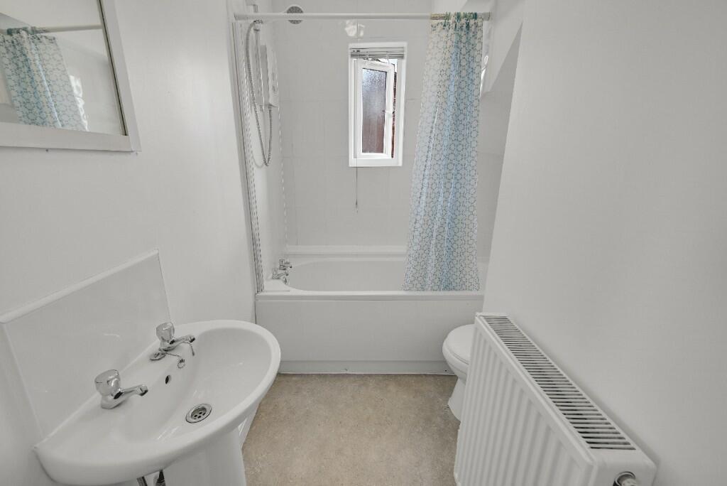 Bright and clean bathroom featuring a white sin...