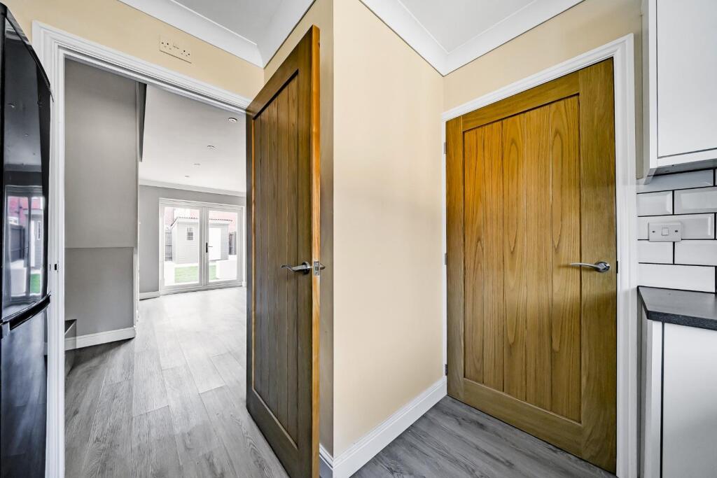 Kitchen with doors to living room and entrance hal
