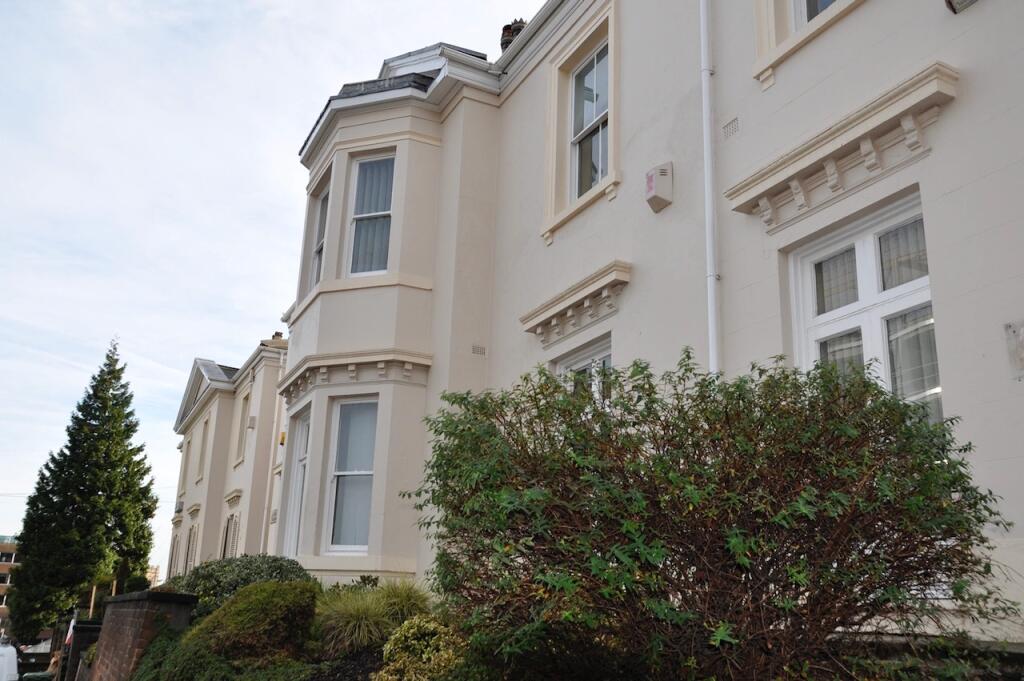 Elegant cream-colored terraced house with class...