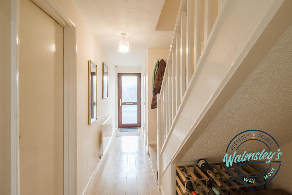 Deep hallway from kitchen towards front door