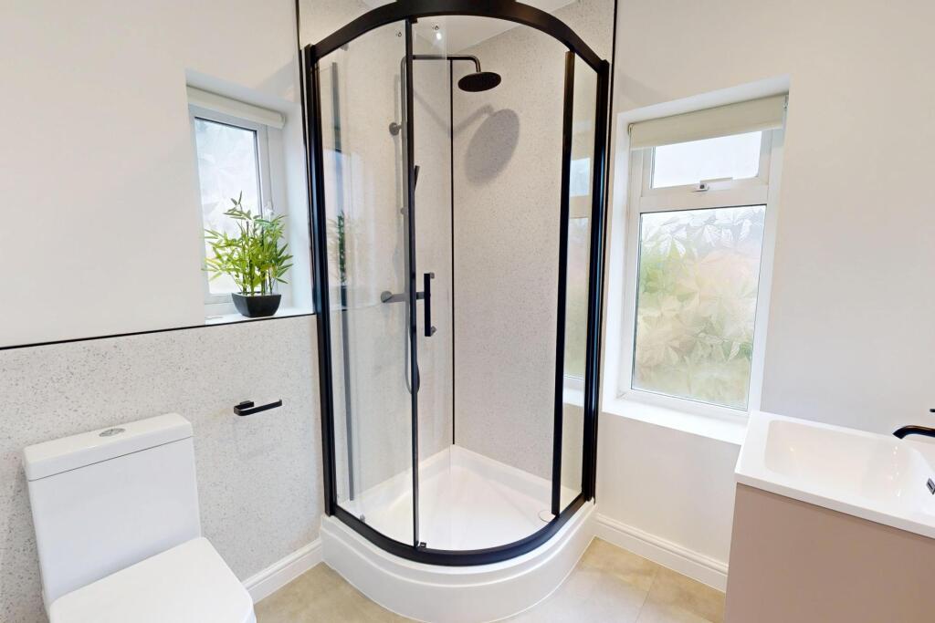 Bright and clean bathroom featuring a spacious ...