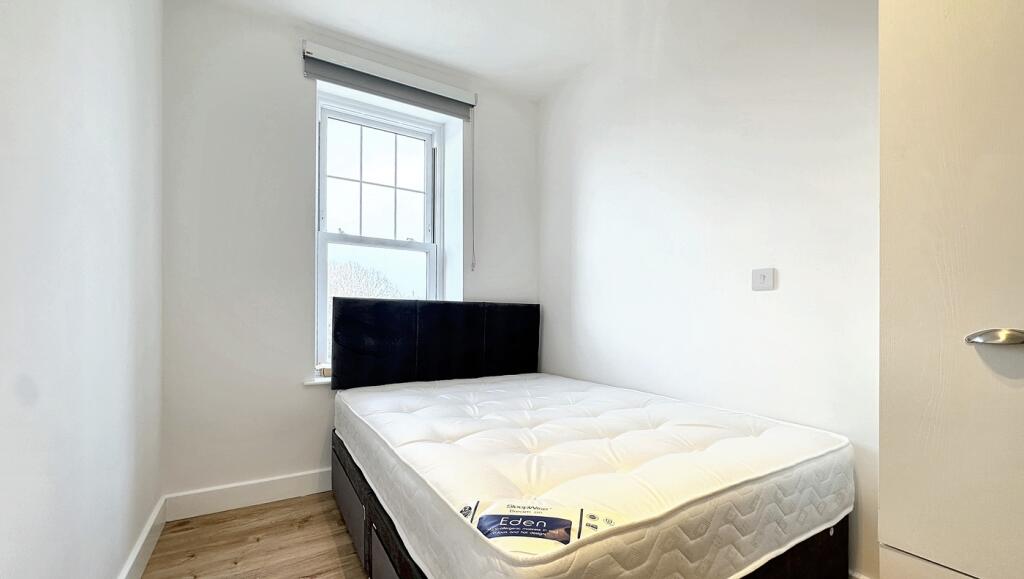 Bright and cozy double bedroom featuring a comf...