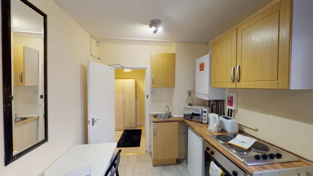 A tidy and functional kitchenette with modern a...