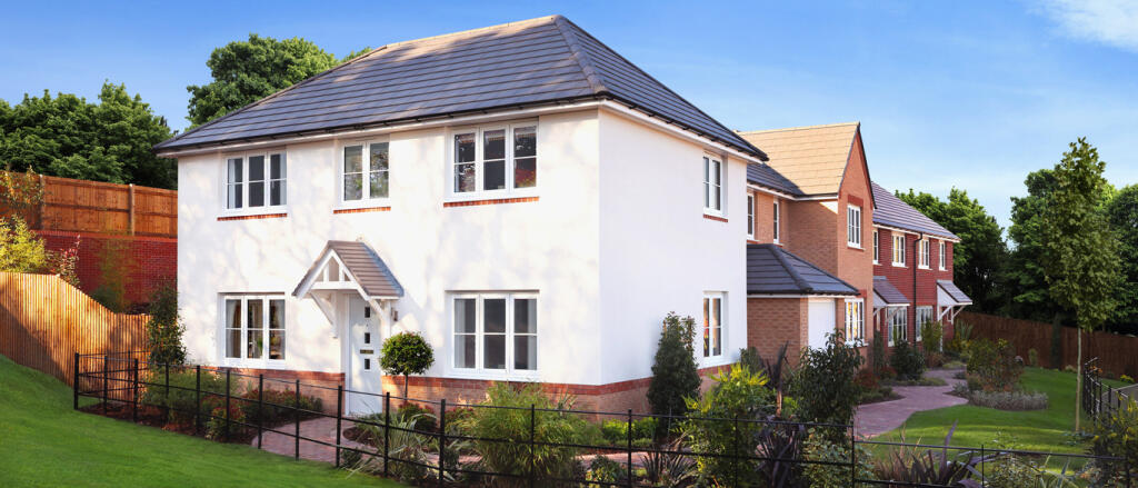 A modern residential building with a white and brick exterior, dark tiled roof, and well-maintained