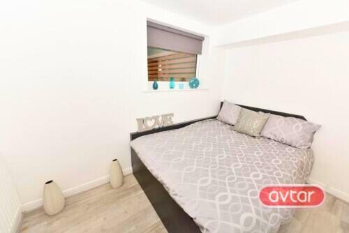 Bright and tidy double bedroom featuring a mode...