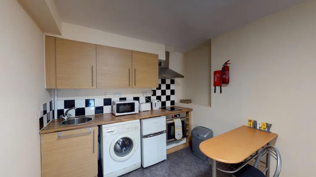 A tidy kitchenette featuring essential applianc...