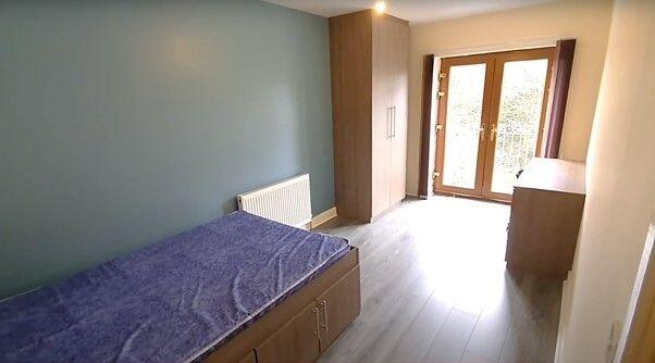 A small but clean and well-lit bathroom with a ...