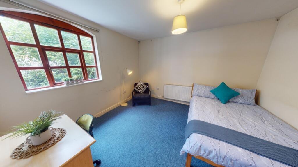 A bright and inviting double bedroom featuring ...