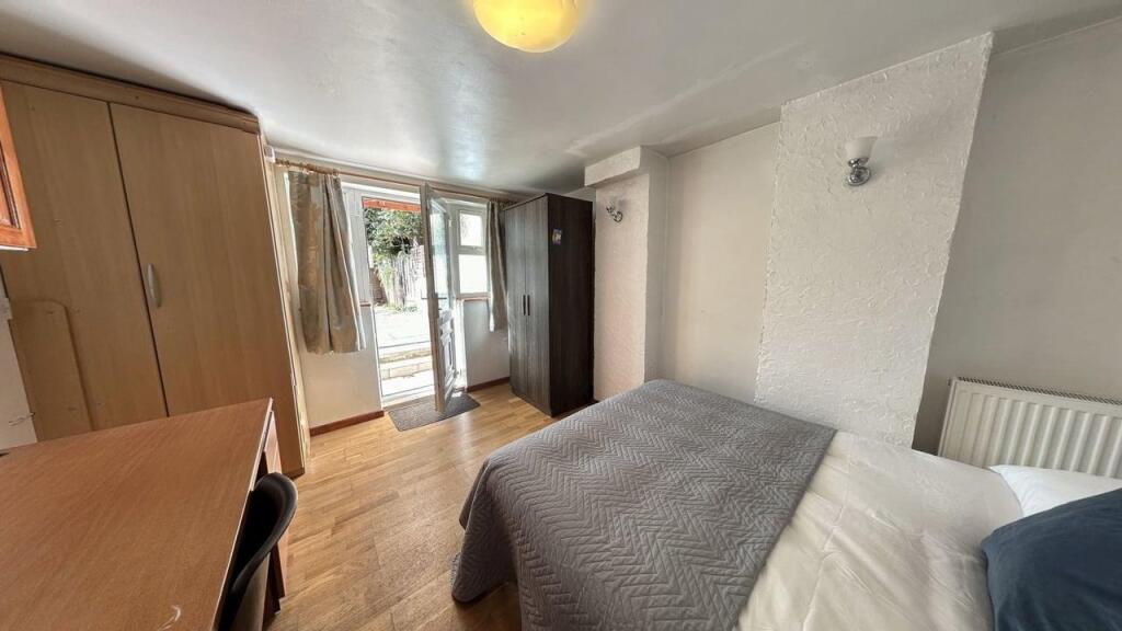 A cozy and well-maintained bedroom featuring a ...