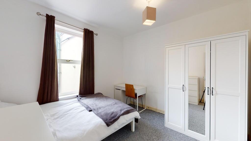 A neat and bright double bedroom featuring a co...