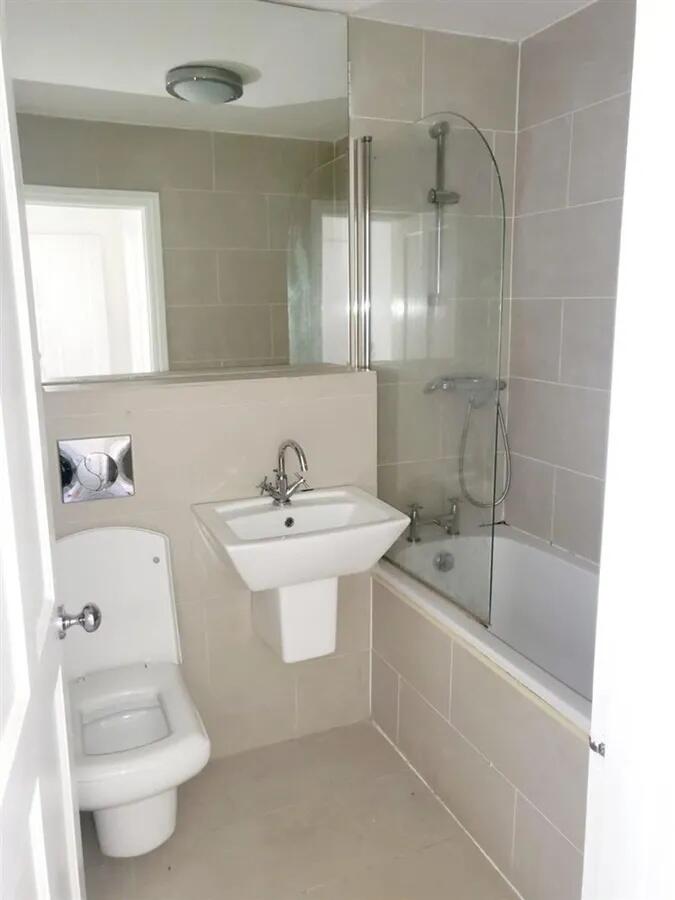 Bright and modern bathroom featuring a clean wh...