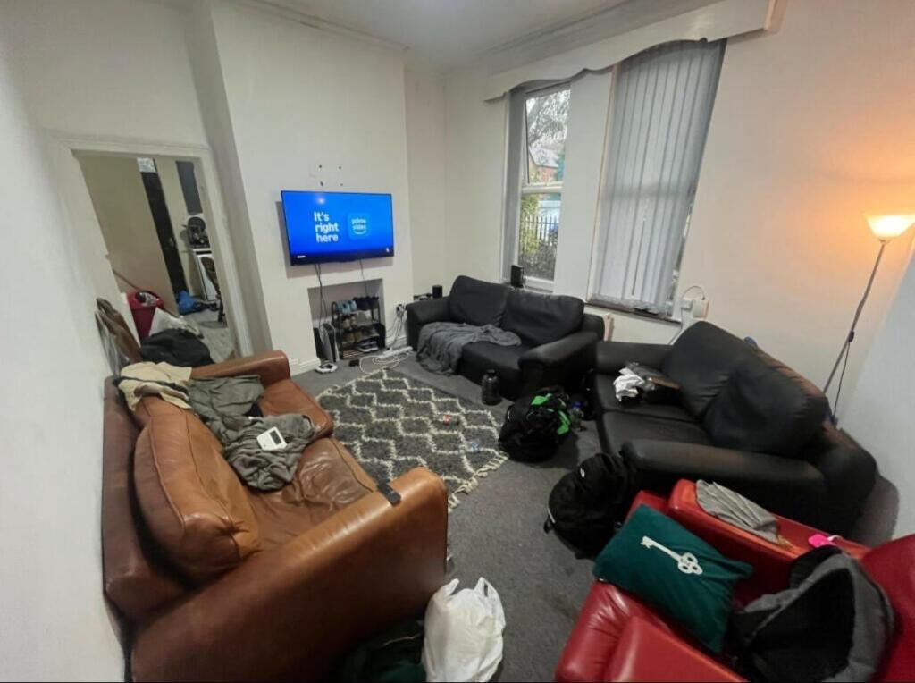 A comfortable, well-lit living room with ample ...