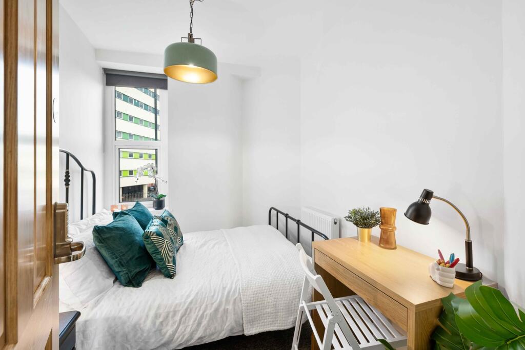 A bright and inviting double bedroom featuring ...