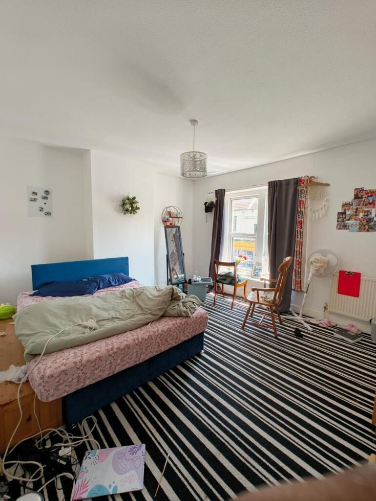 Spacious master bedroom featuring a comfortable...