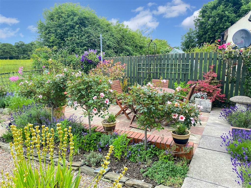 Well-Kept Gardens And Seating Area