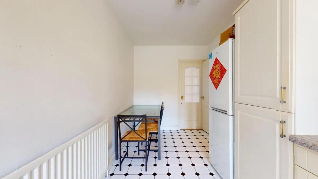 Bright and clean kitchen with classic black and...