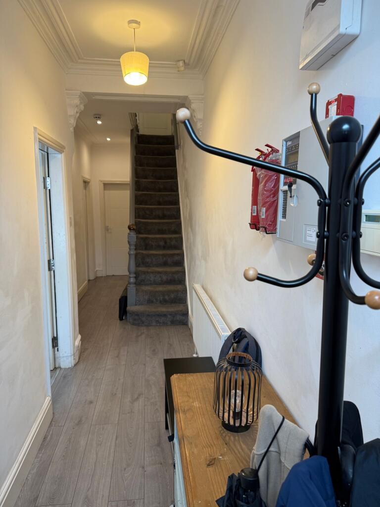 A clean and well-maintained hallway featuring w...