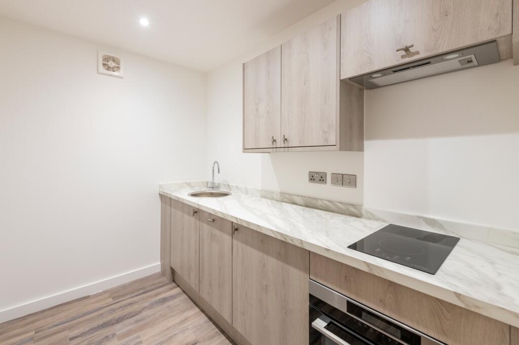 A modern and well-maintained kitchenette with s...